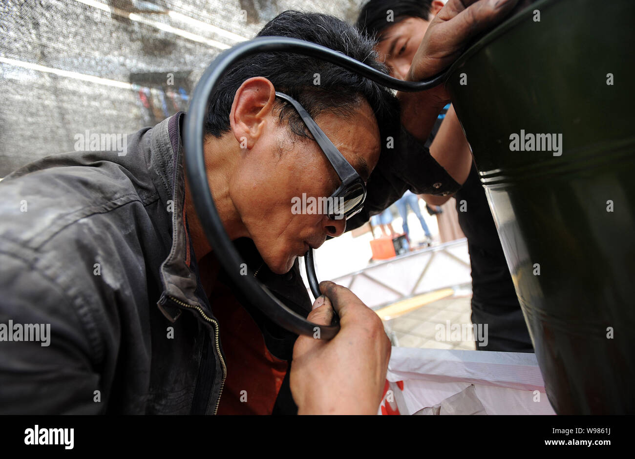 Chinese farmer Shu Mansheng tests an engine of his self-designed