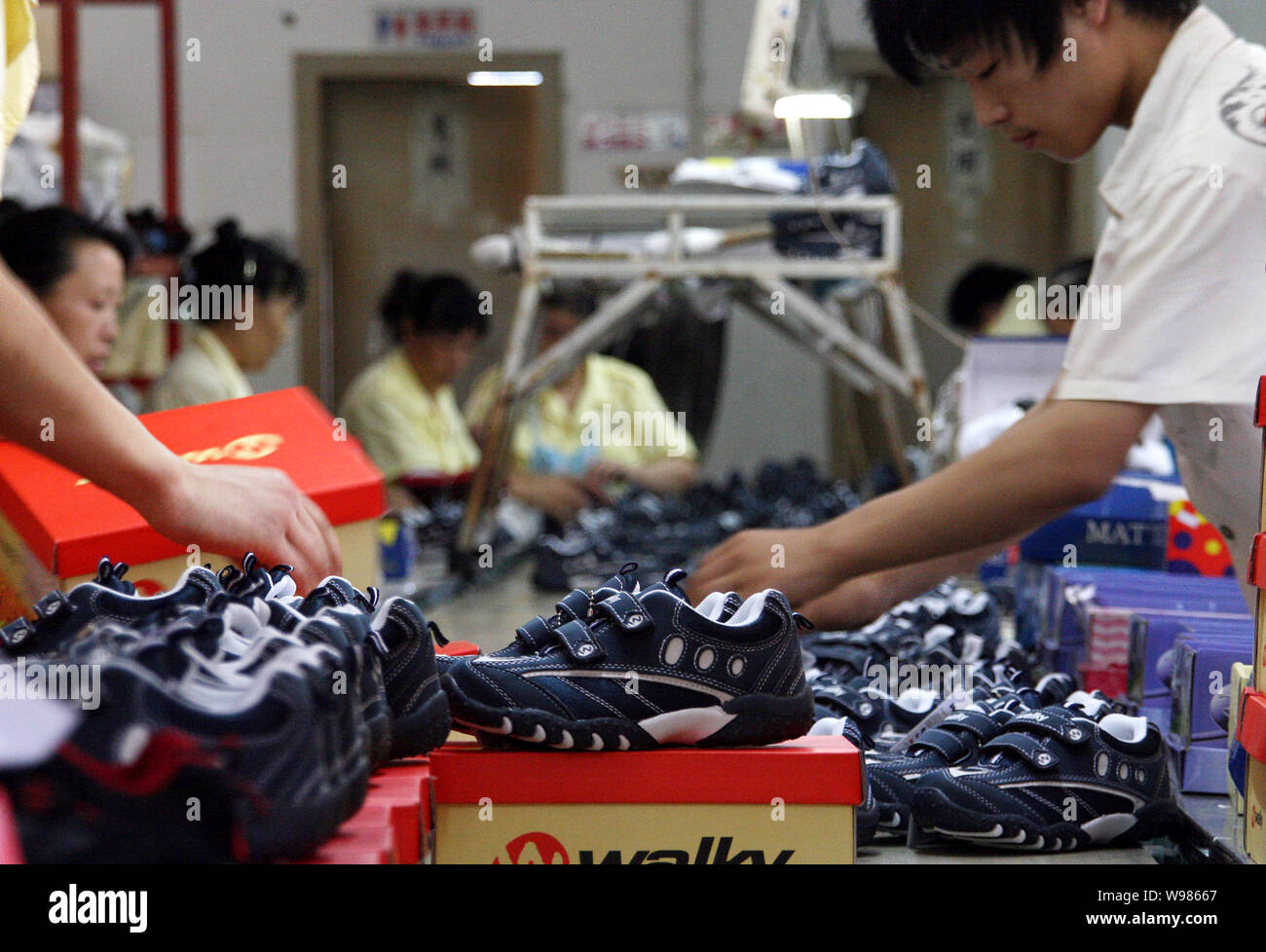 FILE Chinese workers pack kids shoes at the factory of Jinjiang