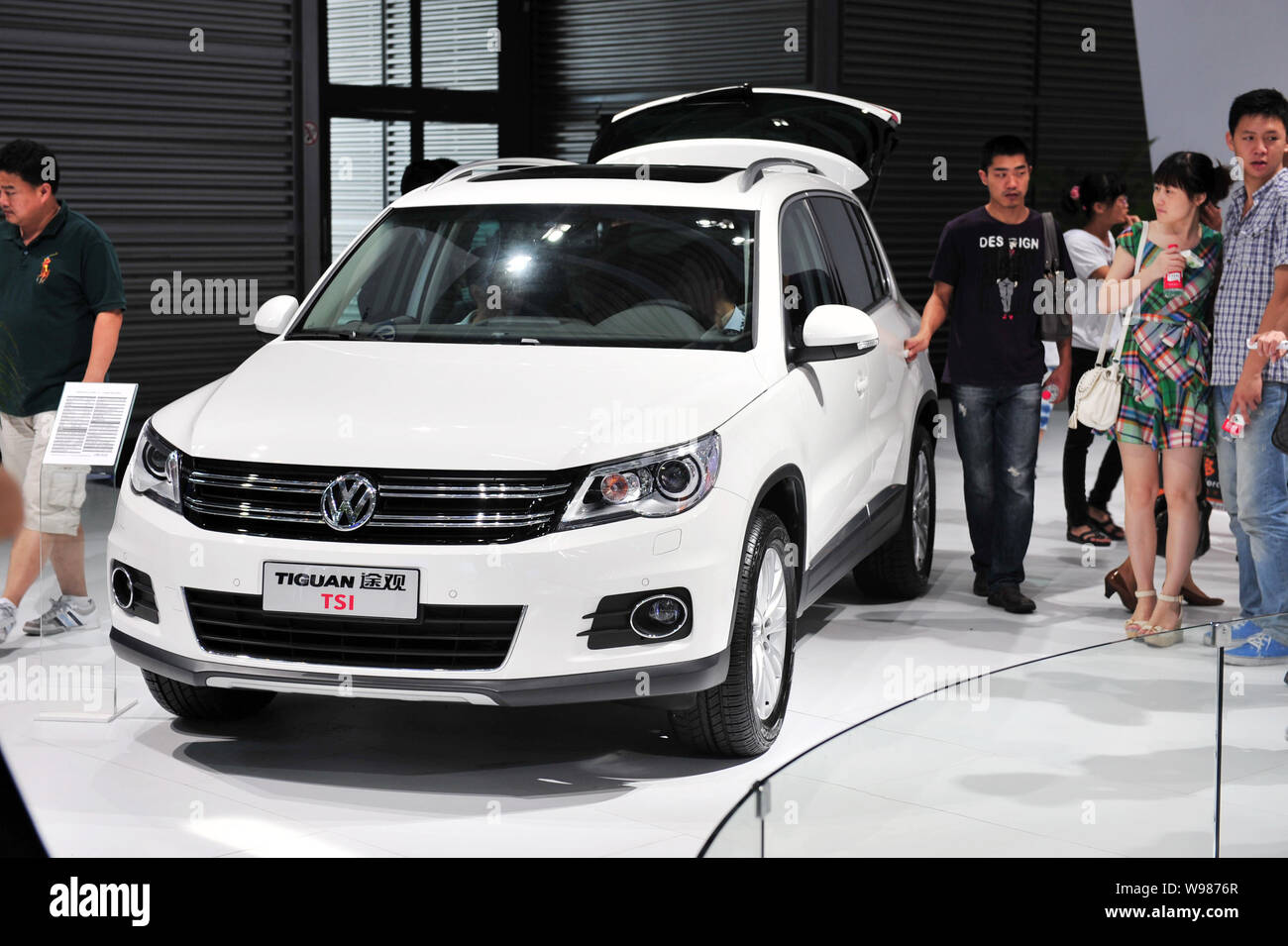 Visitors look at the Shanghai VW TIGUAN TSI during an auto show in Shenzhen, south Chinas Guangdong province, 7 June 2011.  Shanghai Volkswagen sold 8 Stock Photo