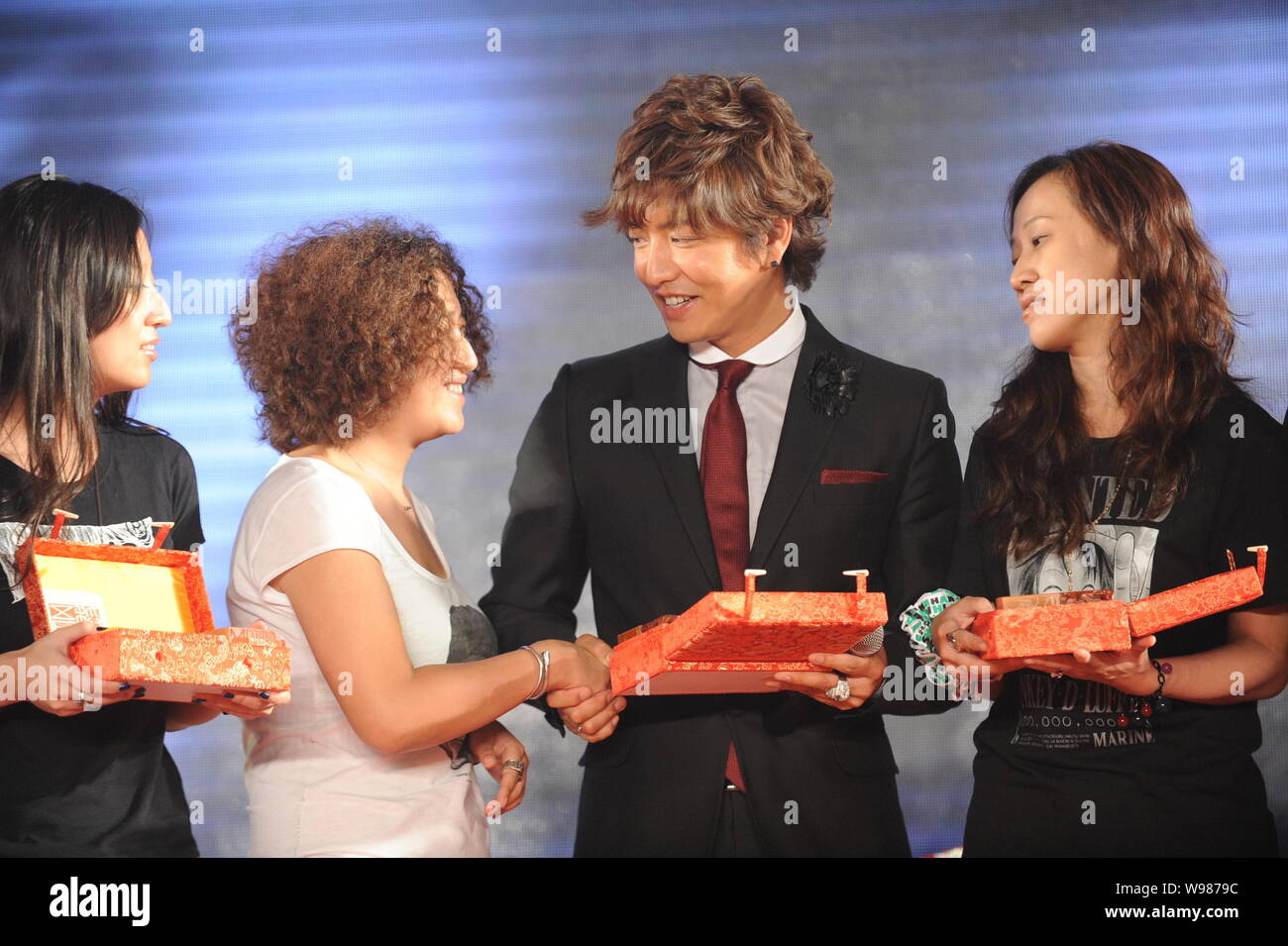 Kimura Takuya Member Of Japanese Band Smap Shakes Hands With His Fan During A Press Conference For Their Concert In Beijing China 16 August 11 Stock Photo Alamy