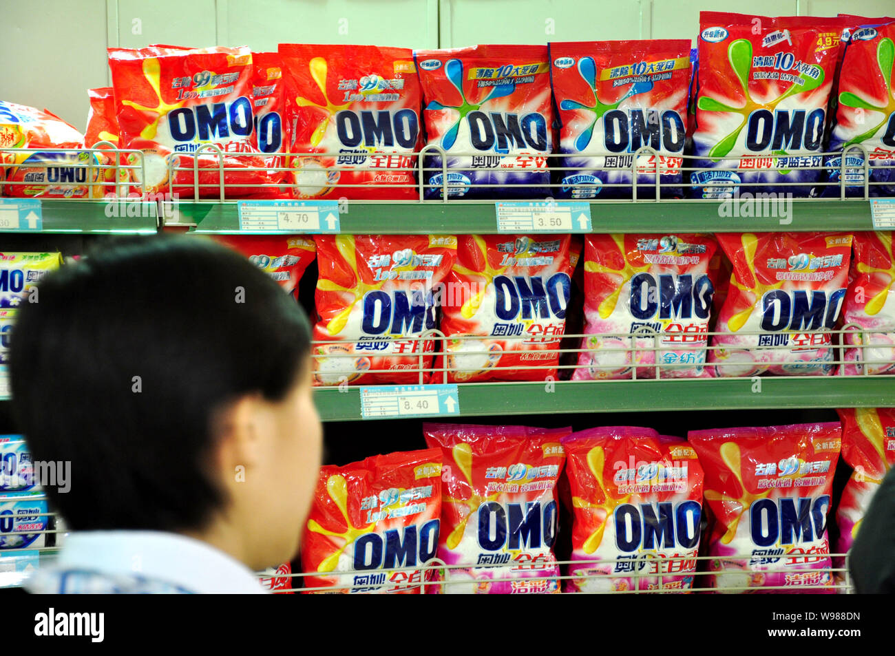 A shopper buys OMO washing powder of Unilever at a supermarket in Yakeshi city, northChinas Inner Mongolia Autonomous Region, 27 March 2011.   Shangha Stock Photo