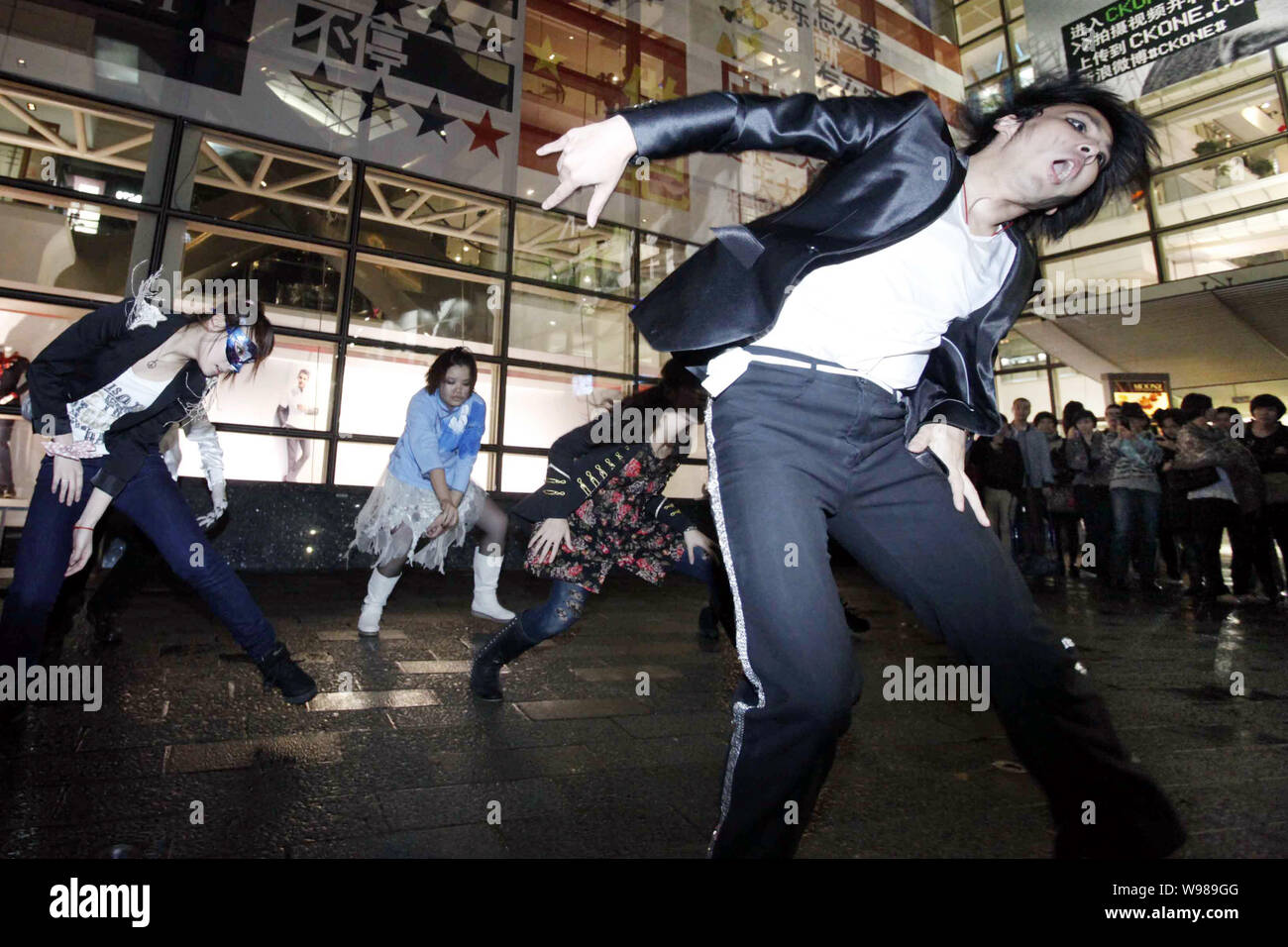 Young Chinese people perform dancing of Michael Jacksons Thriller during a celebration for Halloween at Xintiandi, a tourist attraction complex, in Sh Stock Photo
