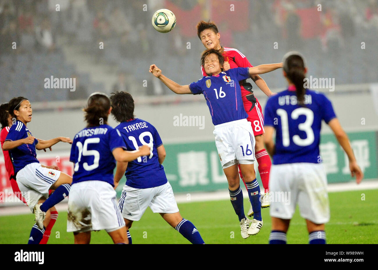 Asuna Tanaka of Japan, back front (#16), challenges Chinas Ma Jun during their Asian womens football qualifiers match for the 2012 London Olympic Game Stock Photo