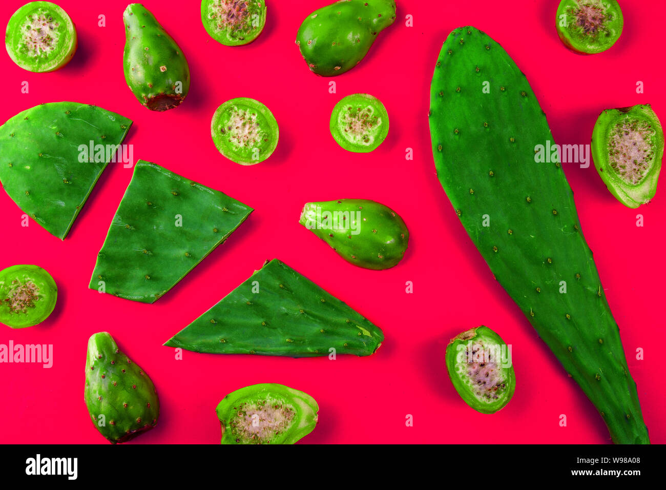 Cactus leaves and cactus fruits tuna on pink background. Creative layout. Top view Stock Photo