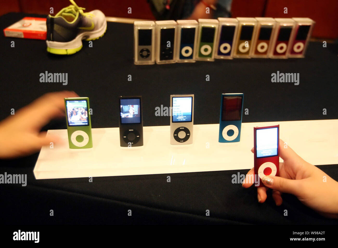 --FILE--Visitors try out Apple iPod nano music players during a launch ceremony in Beijing, China, 22 September 2008.   Apple has unveiled a worldwide Stock Photo