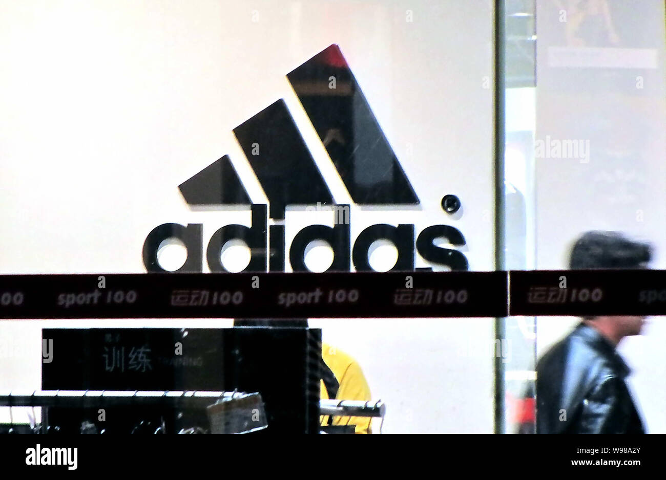 File--A customer is seen at an Adidas store in Shanghai, China, 10 April  2011. An official survey of 300 foreign and domestic enterprises in China  Stock Photo - Alamy