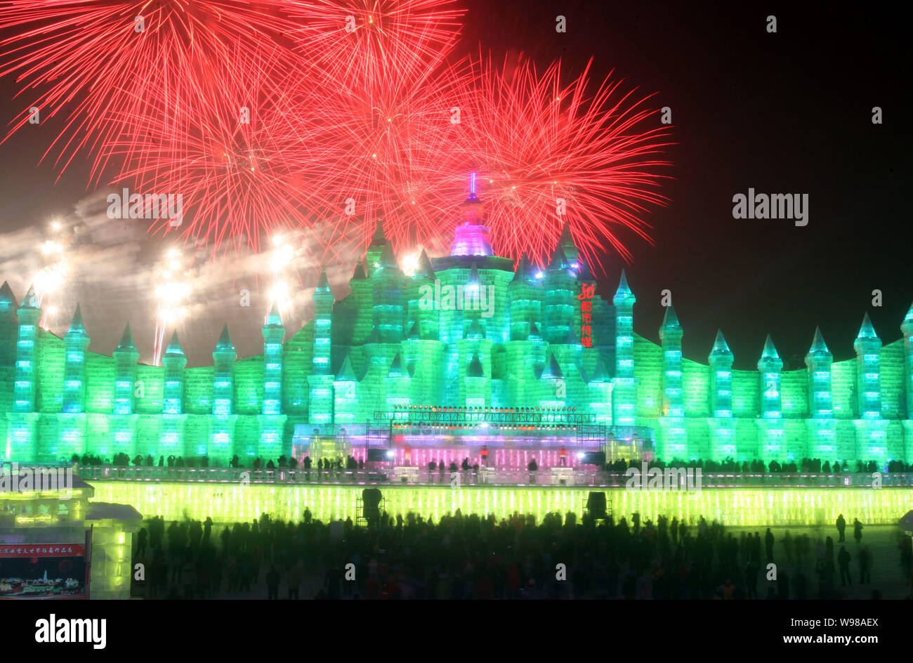 Fireworks explode over illuminated icemade structures during the 27th