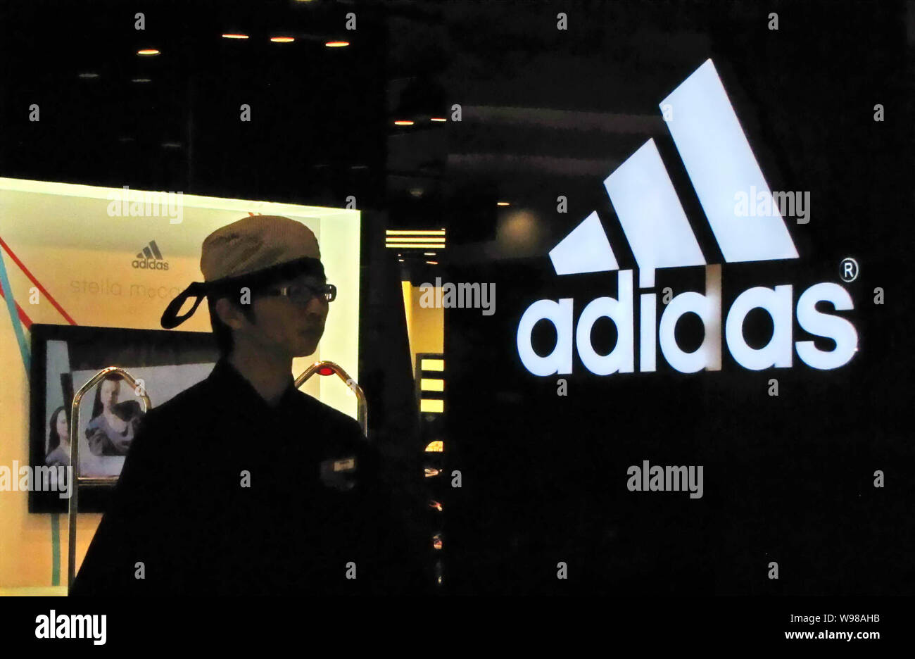 File--A customer is seen at an Adidas store in Shanghai, China, 30 July  2011. An official survey of 300 foreign and domestic enterprises in China  Stock Photo - Alamy