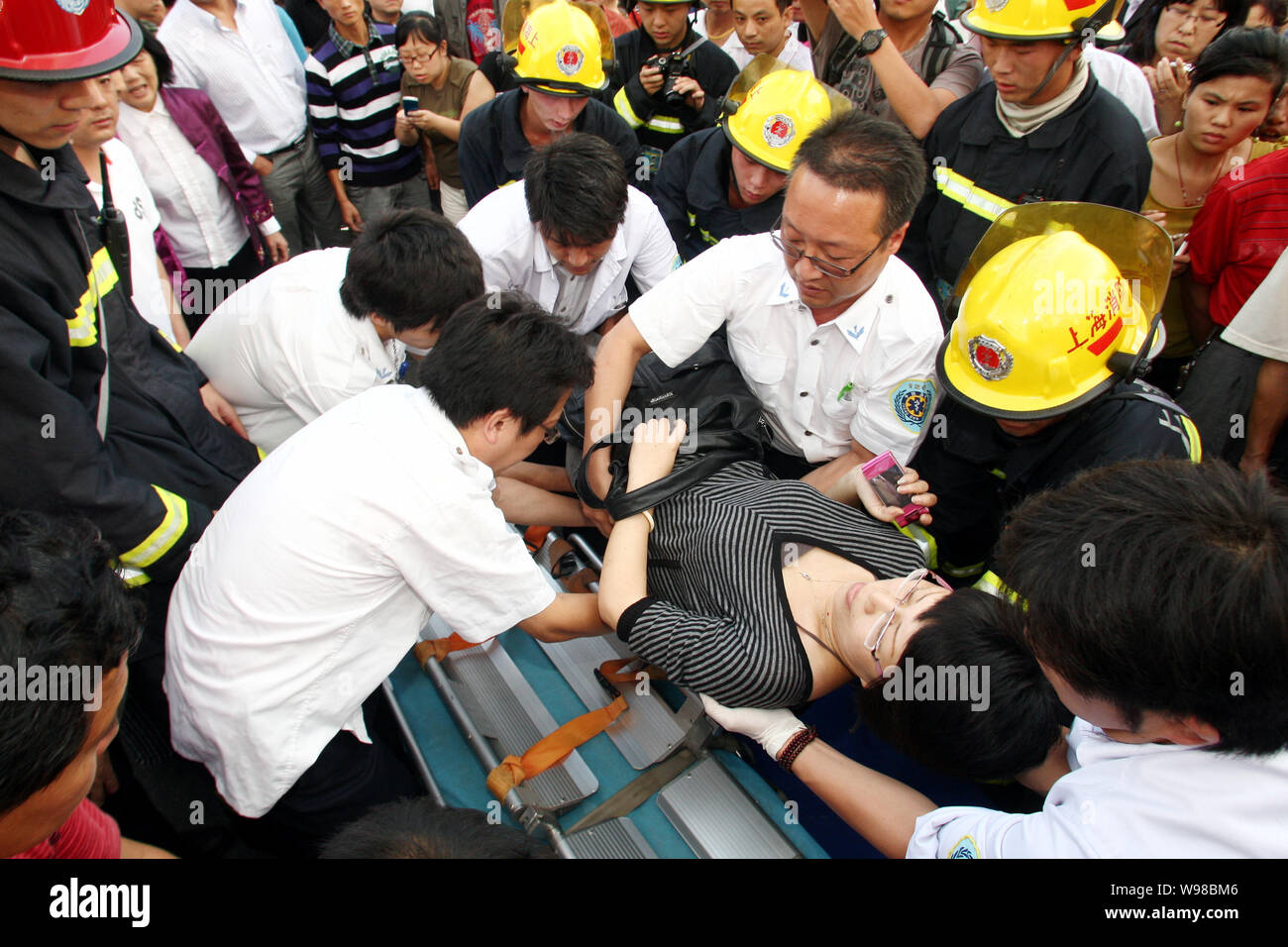 Rescuers put a passenger injured in the Metro Line 10 subway train ...