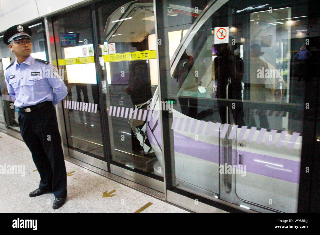 Shanghai Metro Line 10 File--A Police Officer Watches A Subway Train Of The Metro Line 10 Which  Collided With Another Passing Through A Subway Station In Shanghai, China  Stock Photo - Alamy