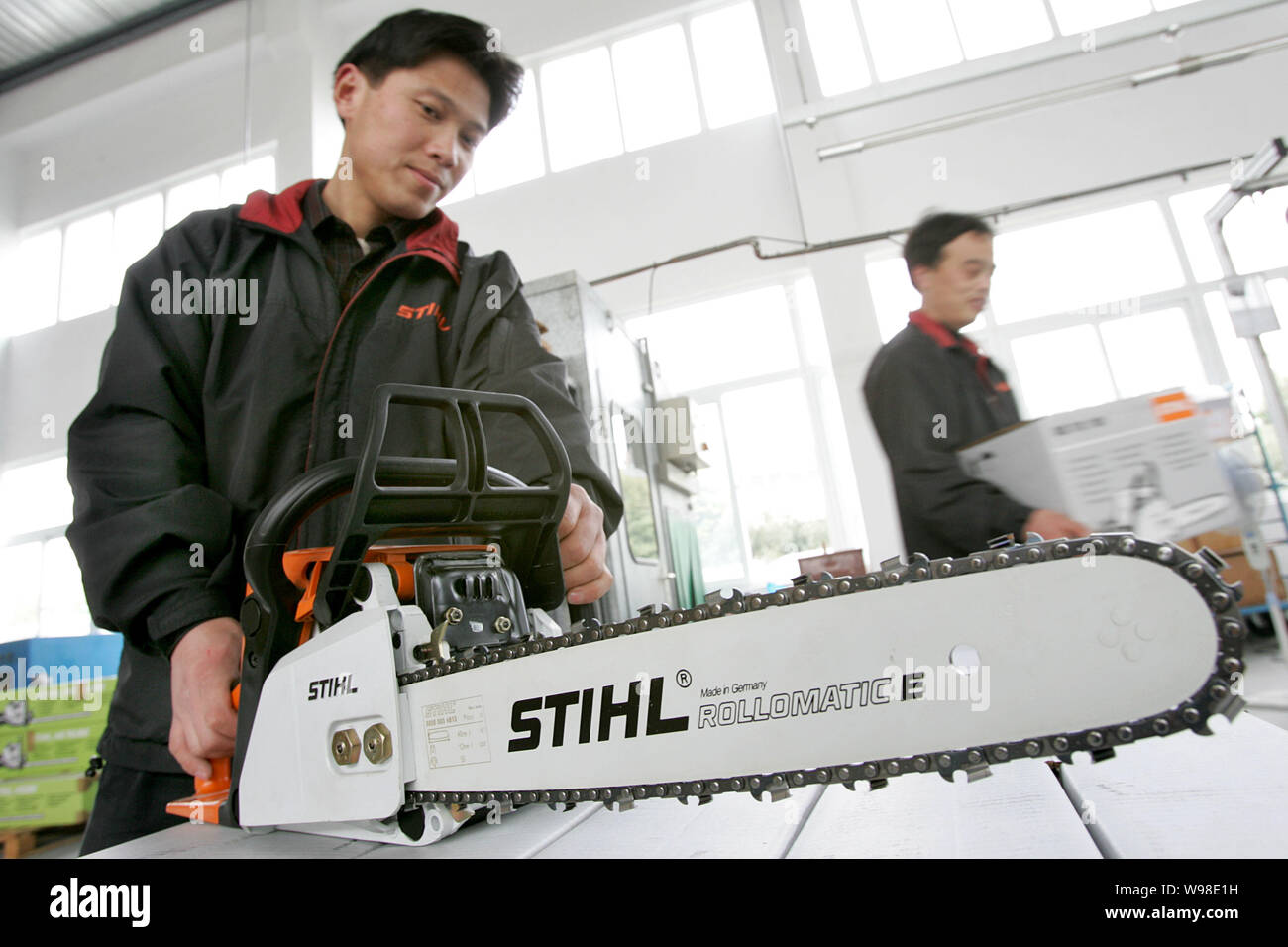 A Chinese Worker Shows An Electric Motor Saw At The Plant Of Taicang Andreas Stihl Powertools Co Ltd In Taicang City East Chinas Jiangsu Province Stock Photo Alamy