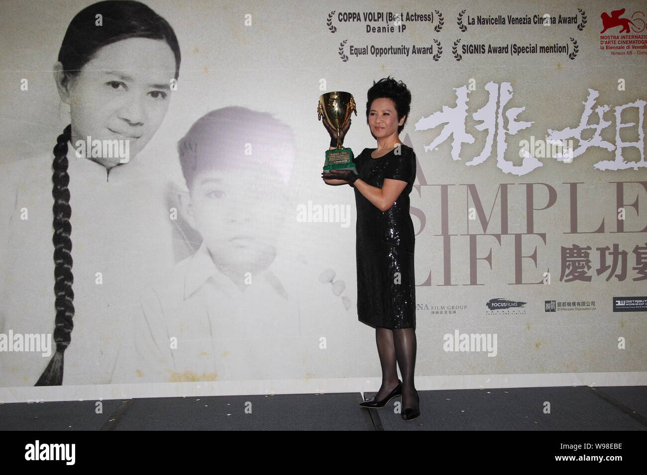 Hongkong singer and actress Deanie Ip Tak-han, winner of the Best Actress award of the 68th Venice International Film Festival, shows her trophy durin Stock Photo