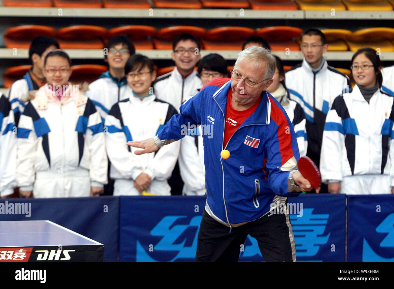 An American veteran player plays table tennis at a high school during