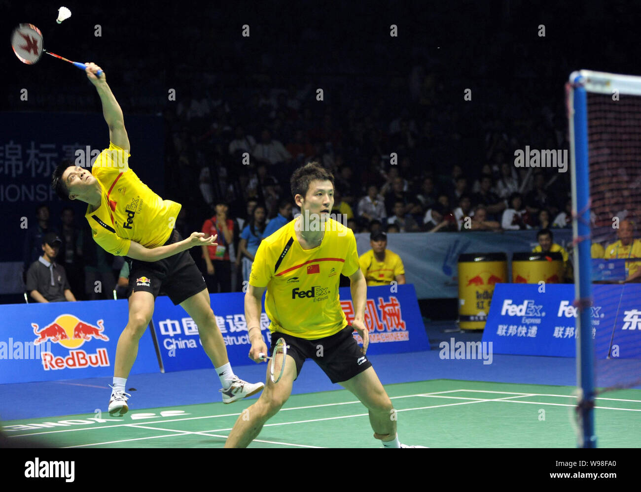 Cai Yun (L) of China, with his partner Fu Haifeng (R), returns a shot against Carsten Mogensen and Jonas Rasmussen of Denmark during the finals of the Stock Photo