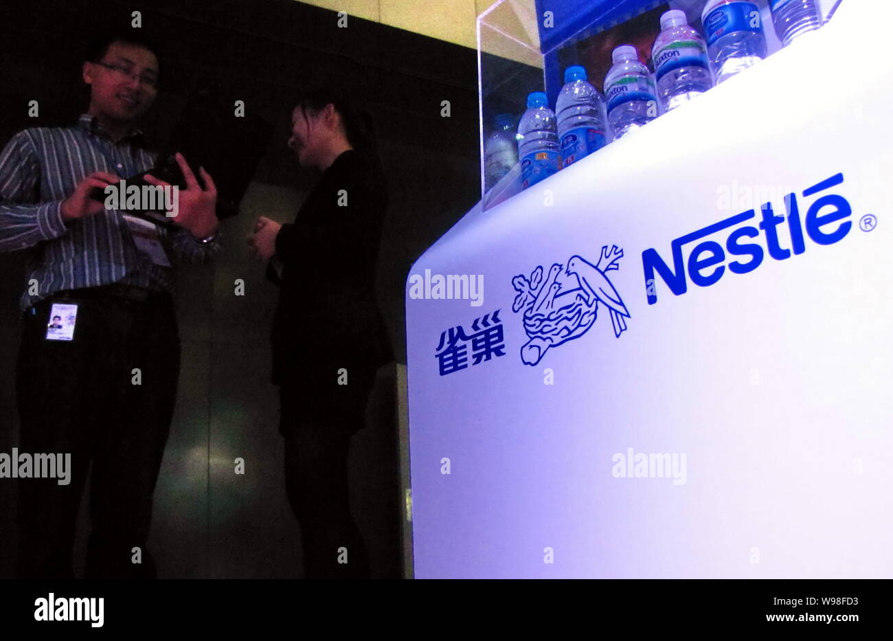 --File--Chinese staff are seen by the stand of Nestle during a fair in Shanghai, China, 25 November 2011.    Chinas confectionery company Hsu Fu Chi I Stock Photo