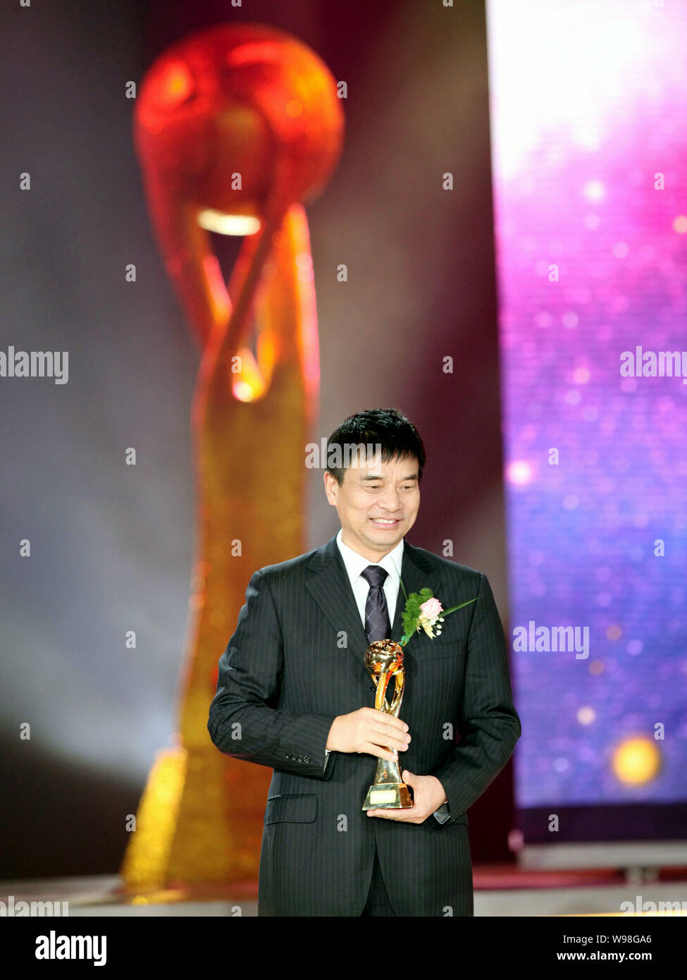 Liu Yonghao, Chairman of New Hope Group, holds the trophy of Annual