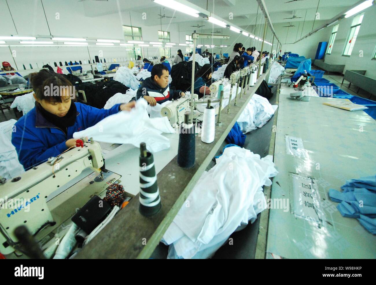 FileWorkers are seen working in a clothing factory in Jiujiang