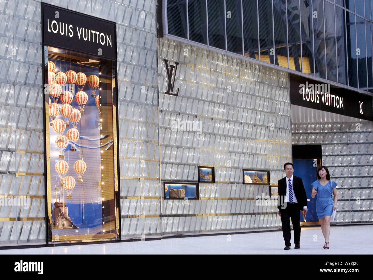 People walk past the Louis Vuitton (LV) boutique at the International  Finance Center (IFC) in the Lujiazui Financial District in Pudong,  Shanghai, Chi Stock Photo - Alamy