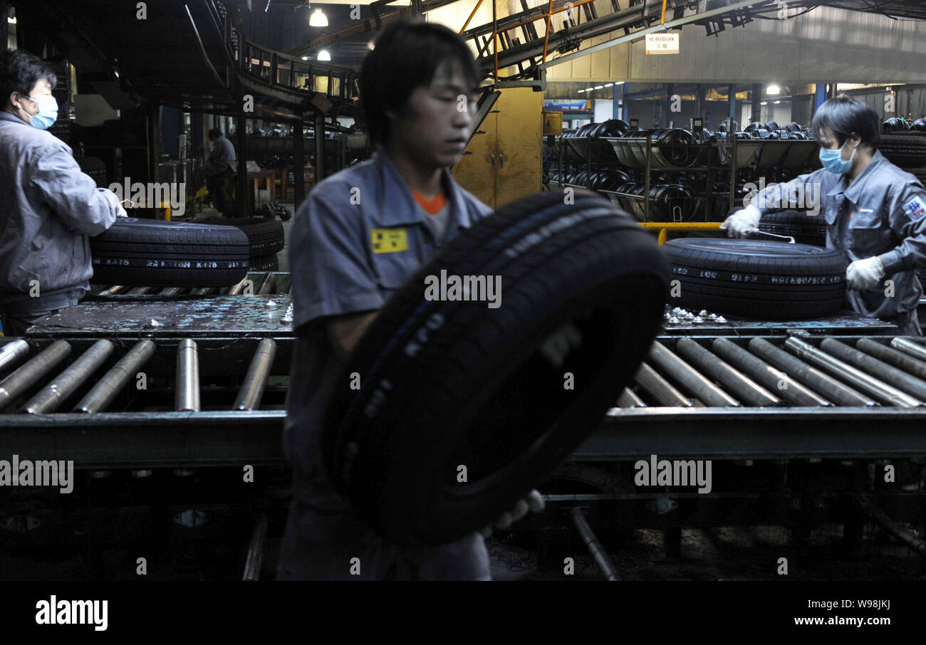 FILEChinese workers manufacture tires on the production line at the factory of Hankook Tire