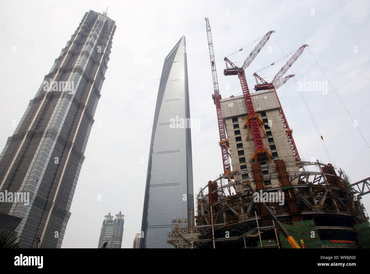 The Shanghai Tower, right, is under construction next to Jinmao Tower ...