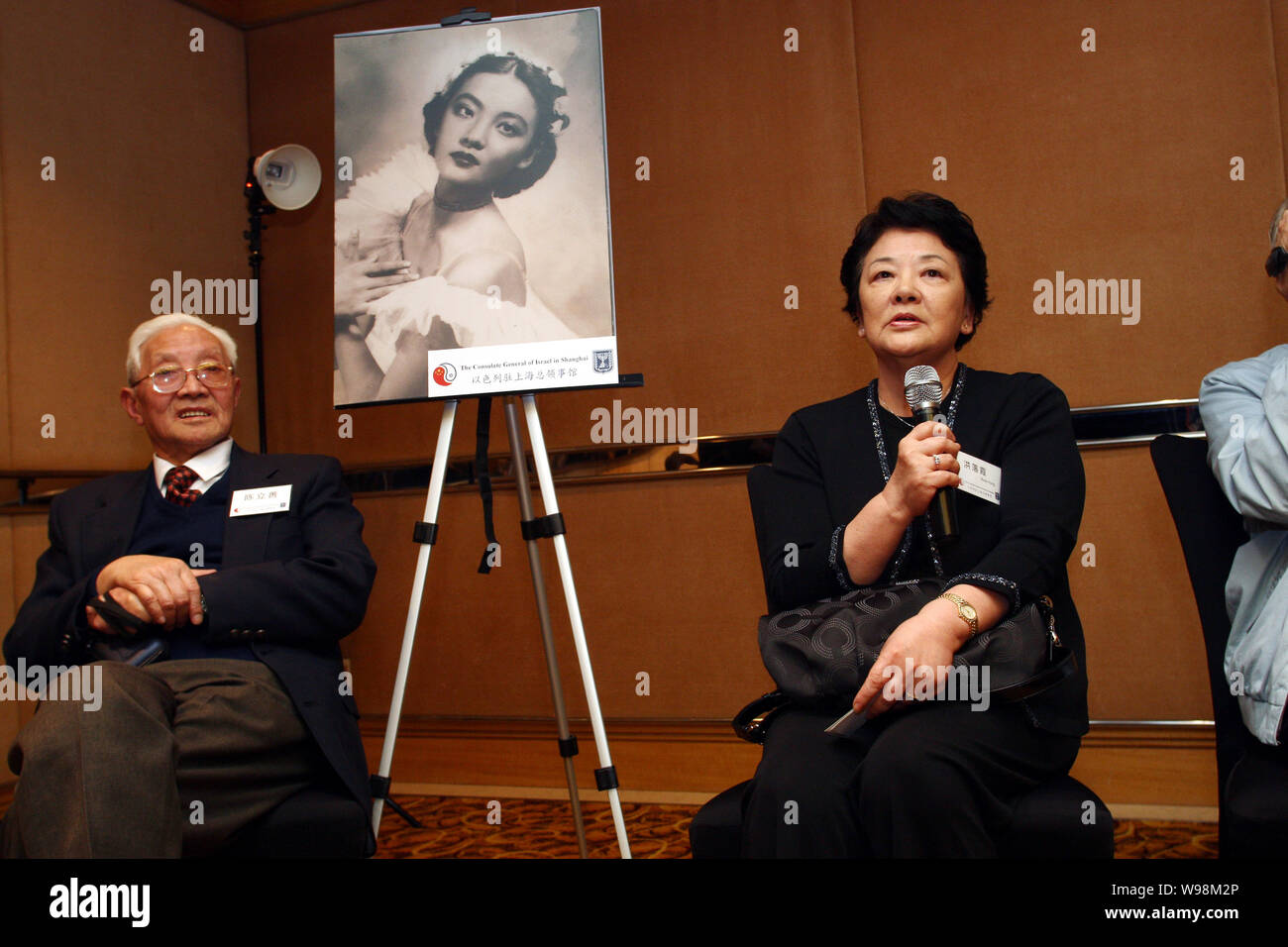 Rosa Hung or Hong Luoxia (right), 74, speaks next to an old photo of