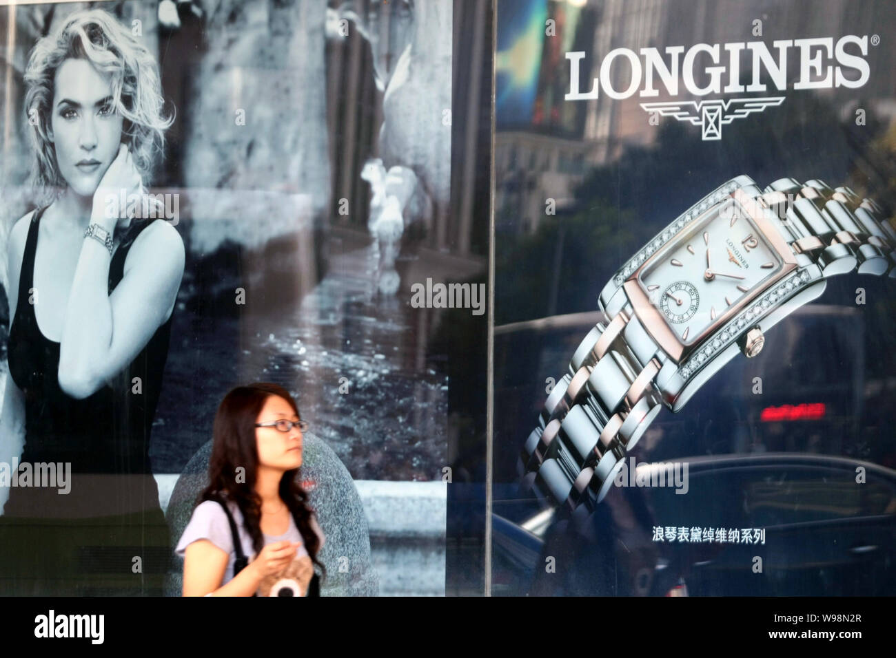 FILE A woman walks past an advertisement for Longines watches in