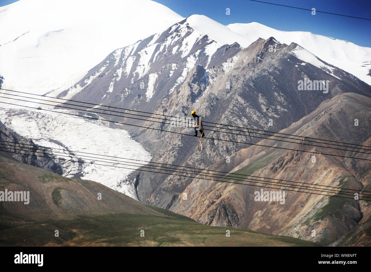 --File--An eletrician checks a section of the Qinghai-Tibet grid in west Chinas Tibet, 24 July 2011.   The checking of Chinas Qinghai-Tibet grid inter Stock Photo