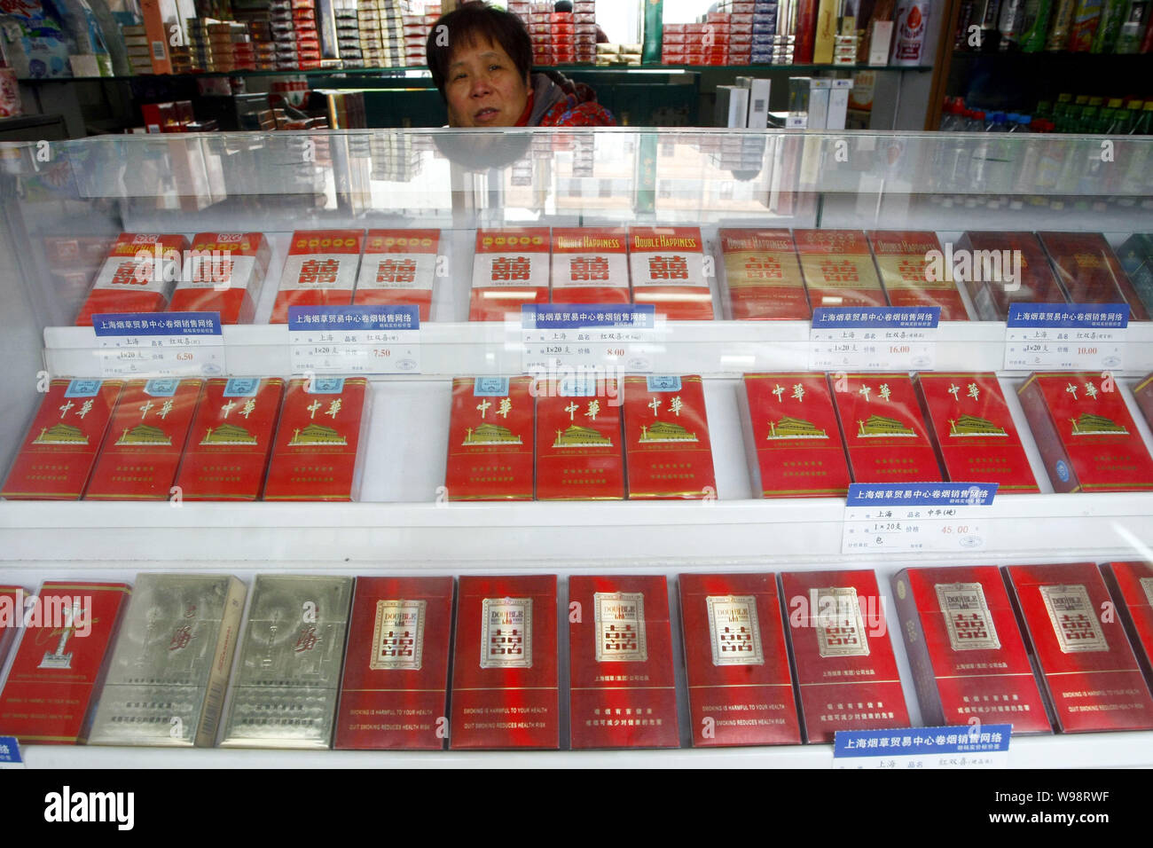 FILE--Boxes of cigarettes are for sale at a shop in Shanghai, China, 17  January 2011. Cigarette manufacturers are cheating consumers by falsely cl  Stock Photo