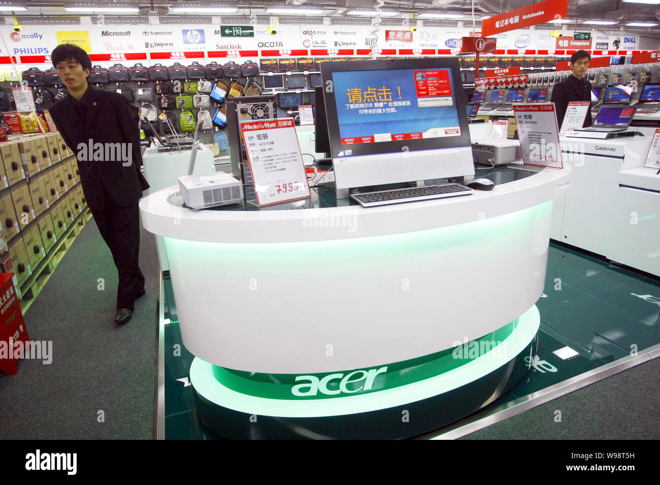 FILE--A man walks past Acer computers for sale at a Media Markt store in  Shanghai, China, 17 November 2010. The sudden change of CEO at PC giant A  Stock Photo - Alamy