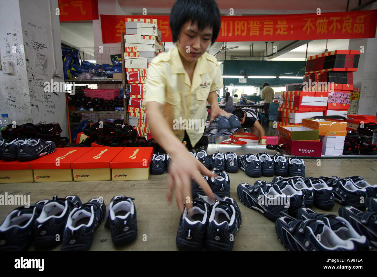 FILE--Chinese workers pack kids shoes at the factory of Jinjiang Haixia  Shoes Co., Ltd. in Jinjiang city, southeast Chinas Fujian province, 29 June  Stock Photo - Alamy