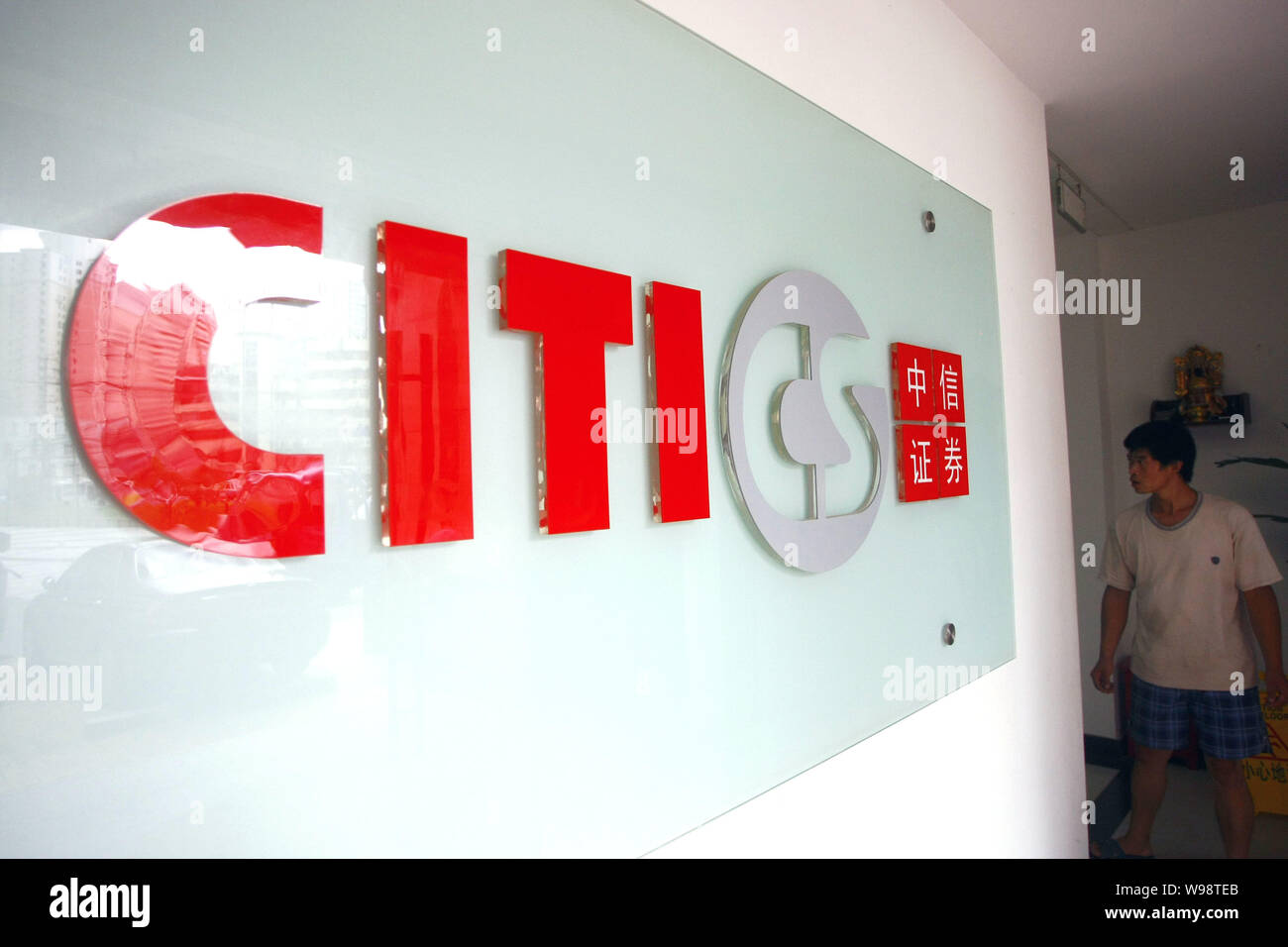 --File--A local resident walks past the signage of CITIC (China International Trust and Investment Corporation) Securities in Shanghai, China, 2 Septe Stock Photo