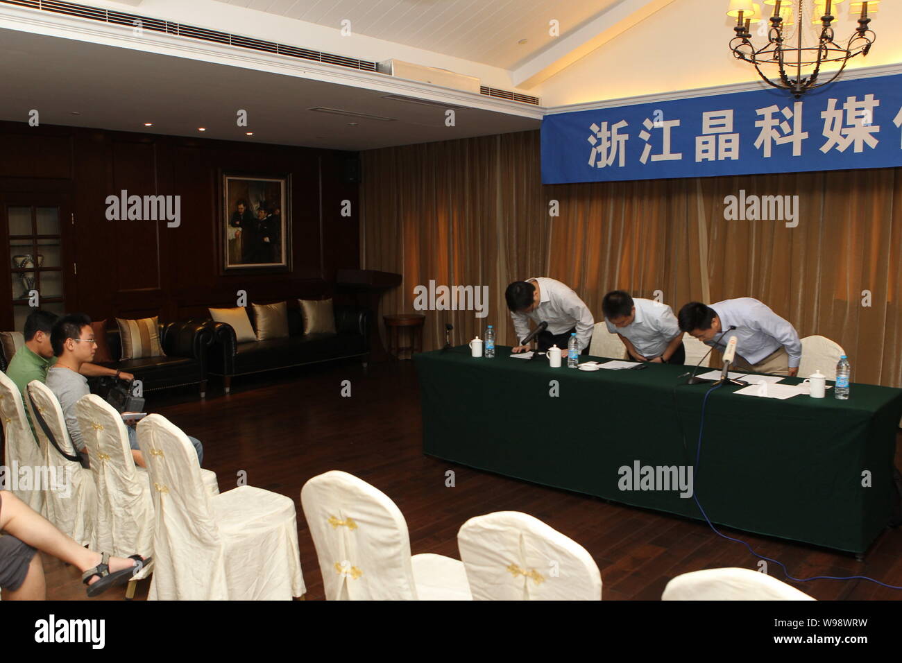 The management of Jinko Solar Holding Co., Ltd. bow to the media expressing their apology on the pollution matter at a press conference in Haining cit Stock Photo