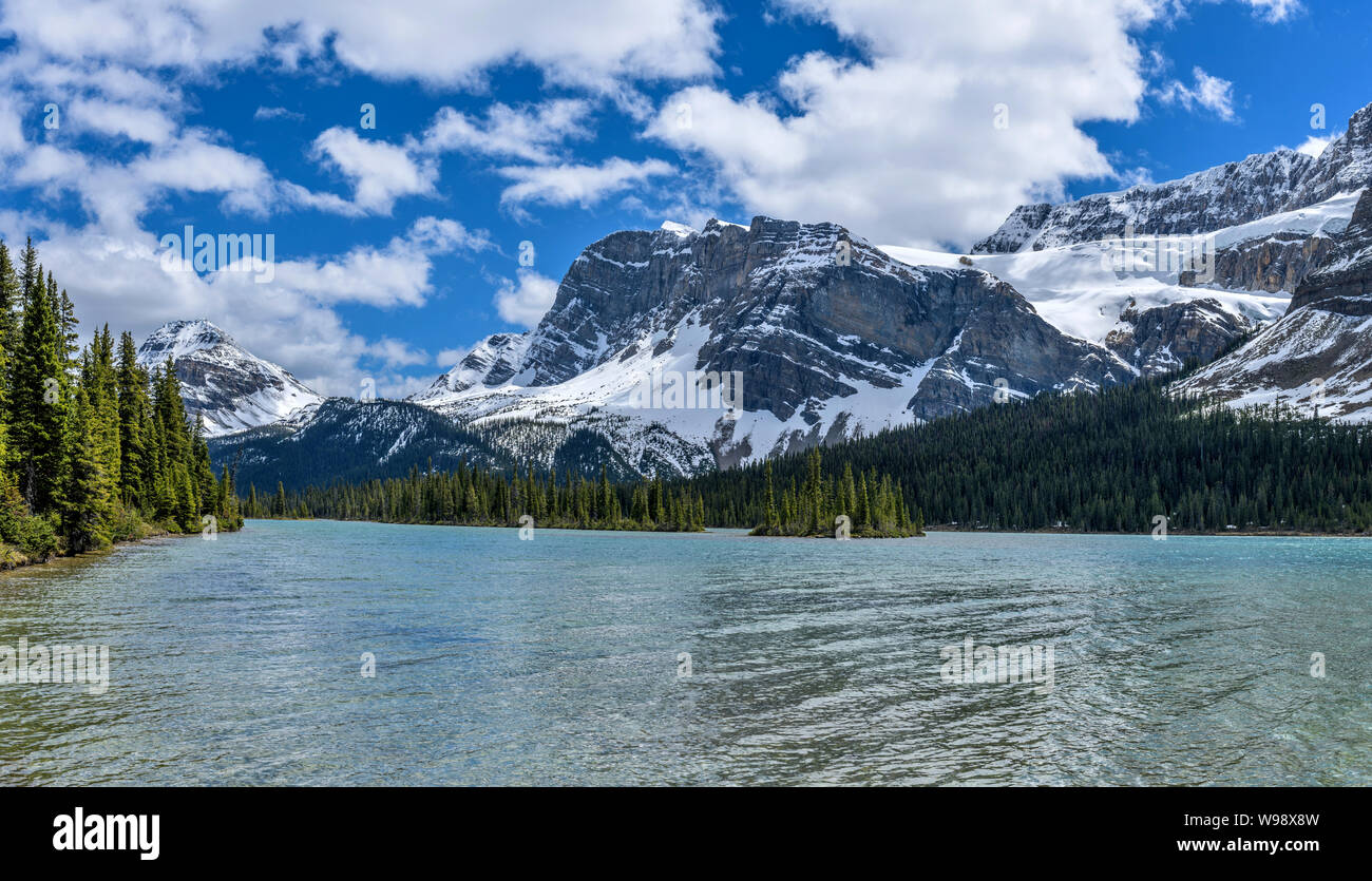 Mountain, Glacier and Lake - A panoramic Spring view of Bow Peak, Bow Crow Peak and Crowfoot Glacier at shore of Bow Lake, Banff National Park, AB. Stock Photo
