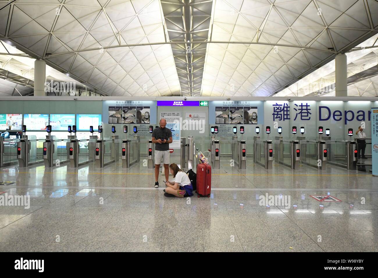 Beijing, China. 12th Aug, 2019. Stranded passengers are seen at Hong Kong International Airport in Hong Kong, south China, Aug. 12, 2019. All flights in and out of China's Hong Kong Special Administrative Region were cancelled on Monday due to a protest held in the Hong Kong International Airport, according to local airport authority. Credit: Lui Siu Wai/Xinhua/Alamy Live News Stock Photo