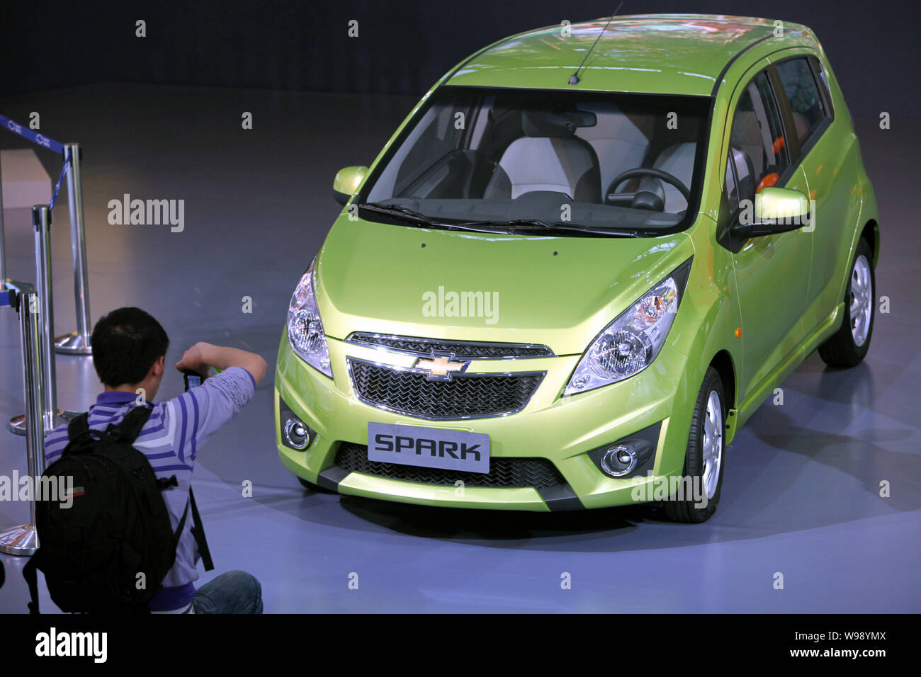 --File-- A visitor takes photos of a Chevrolet Spark during an auto show in Guangzhou city, south Chinas Guangdong Province, December 20, 2010.   Gene Stock Photo