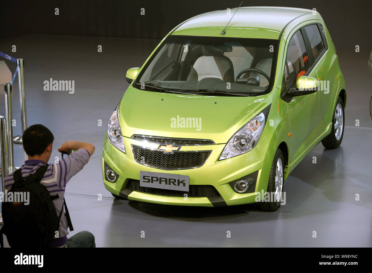 --File-- A visitors takes photos of a Chevrolet Spark of Shanghai GM during an auto show in Guangzhou city, south Chinas Guangdong Province, December Stock Photo