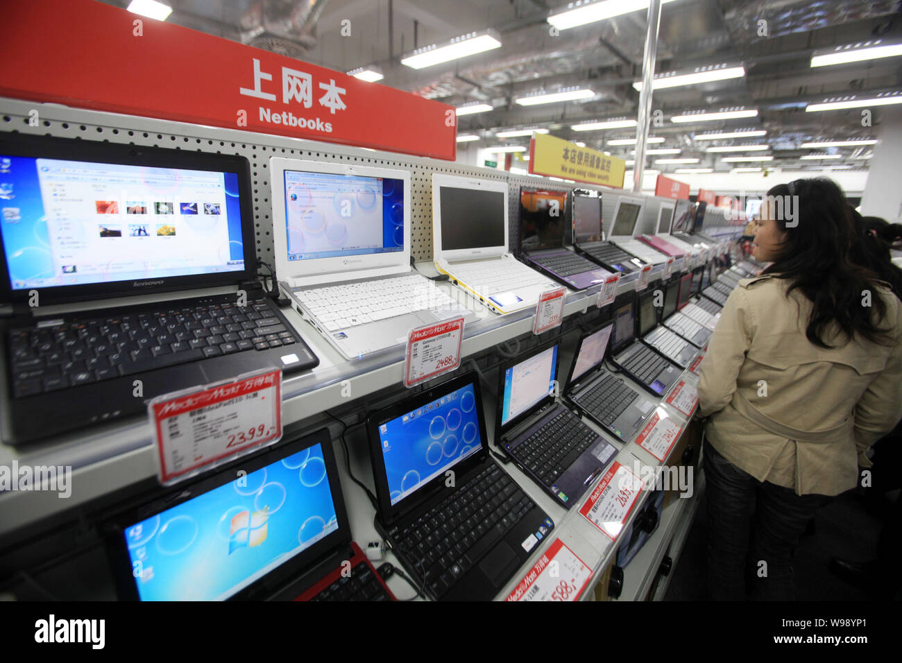 FILE--Customers shop laptop computers at a Media Markt store in Shanghai, China, 18 November 2010. China set to surpass the U.S. in PC ship Stock Photo - Alamy