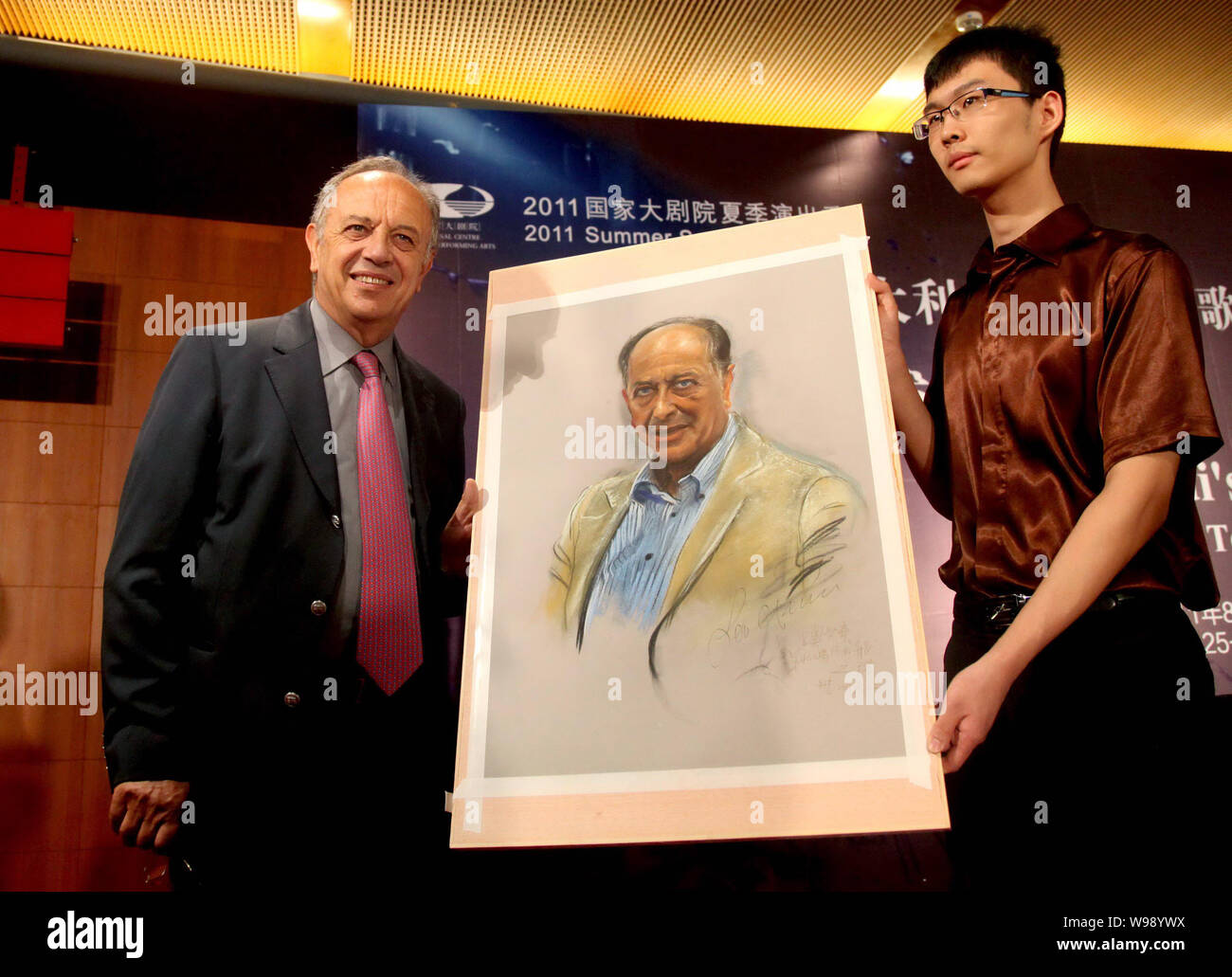 Italian singer Leo Nucci poses with his portray during a press conference for the opera, Rigoletto, in Beijing, China, 23 August 2011. Stock Photo