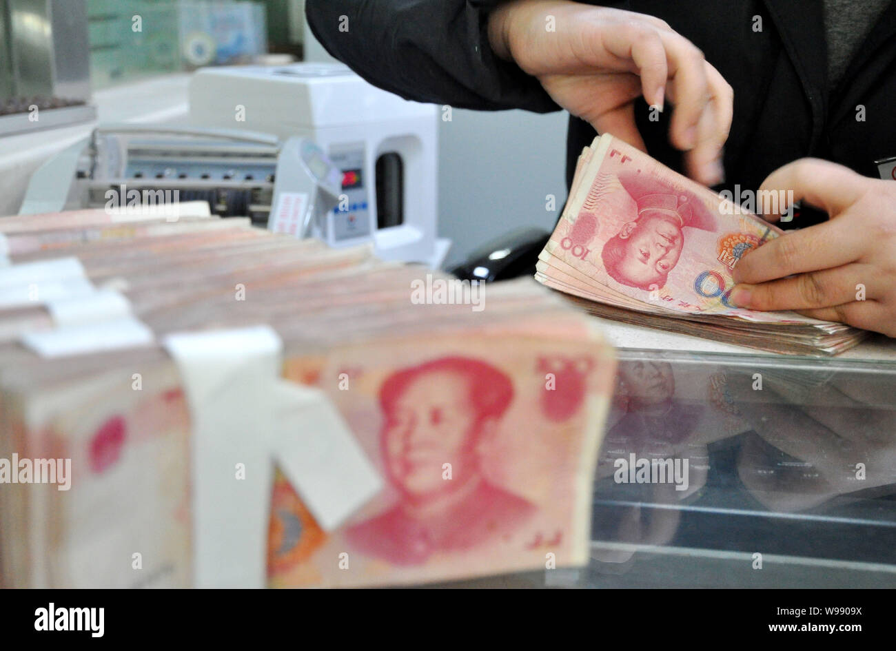 Counting Rmb A Chinese clerk counts RMB (renminbi) yuan banknotes at a bank in ...