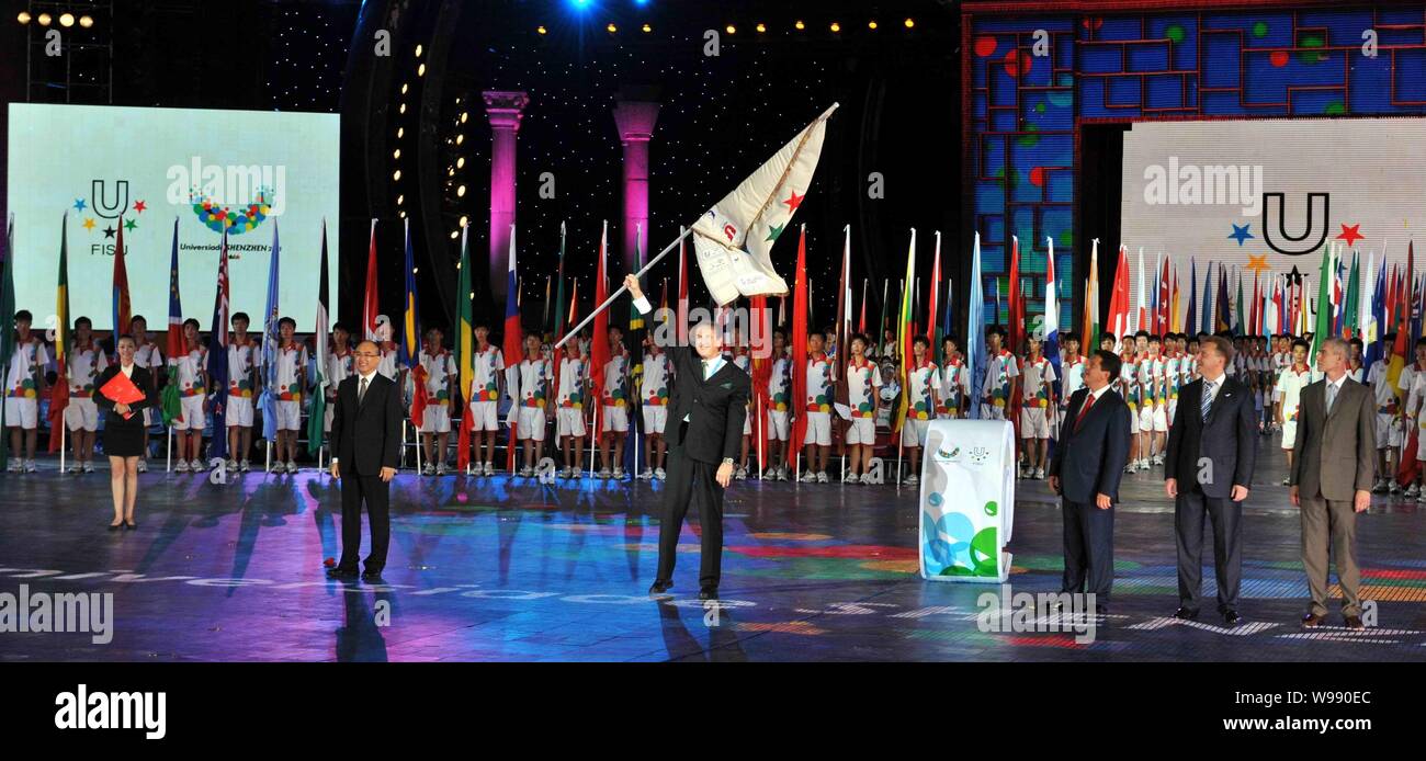 Vice President Alexander Rutskoy of Russia flourishes the FISU flag at the closing ceremony of 26th Summer Universiade in Shenzhen, south Chinas Guang Stock Photo