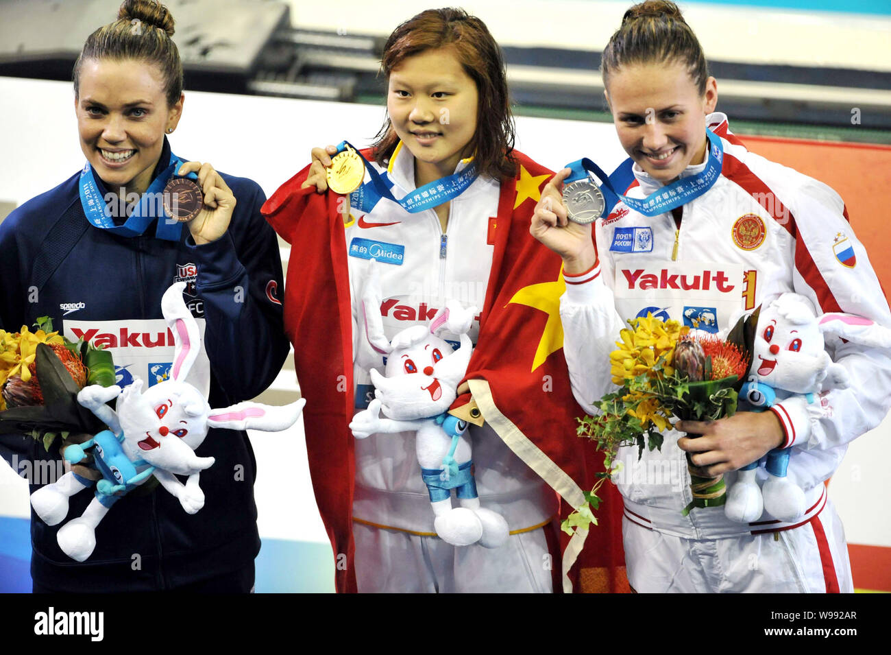 (From left) Bronze medalist Natalie Coughlin of the United States, gold medalist Zhao Jing of China and silver medalist Anastasia Zueva of Russia show Stock Photo