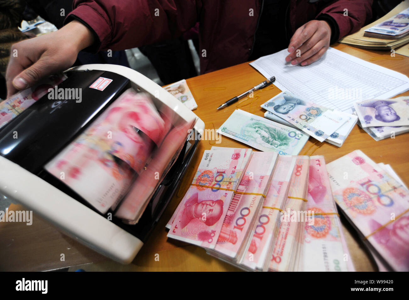 Counting Rmb A Chinese clerk counts RMB (renminbi) yuan banknotes at a bank in Haian ...