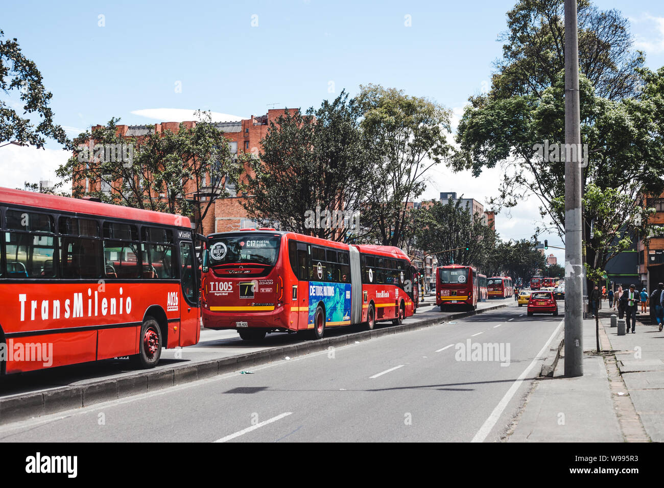 The red Transmilenio public bus system in the bus lane through the center of Bogotá, Colombia's capital city Stock Photo