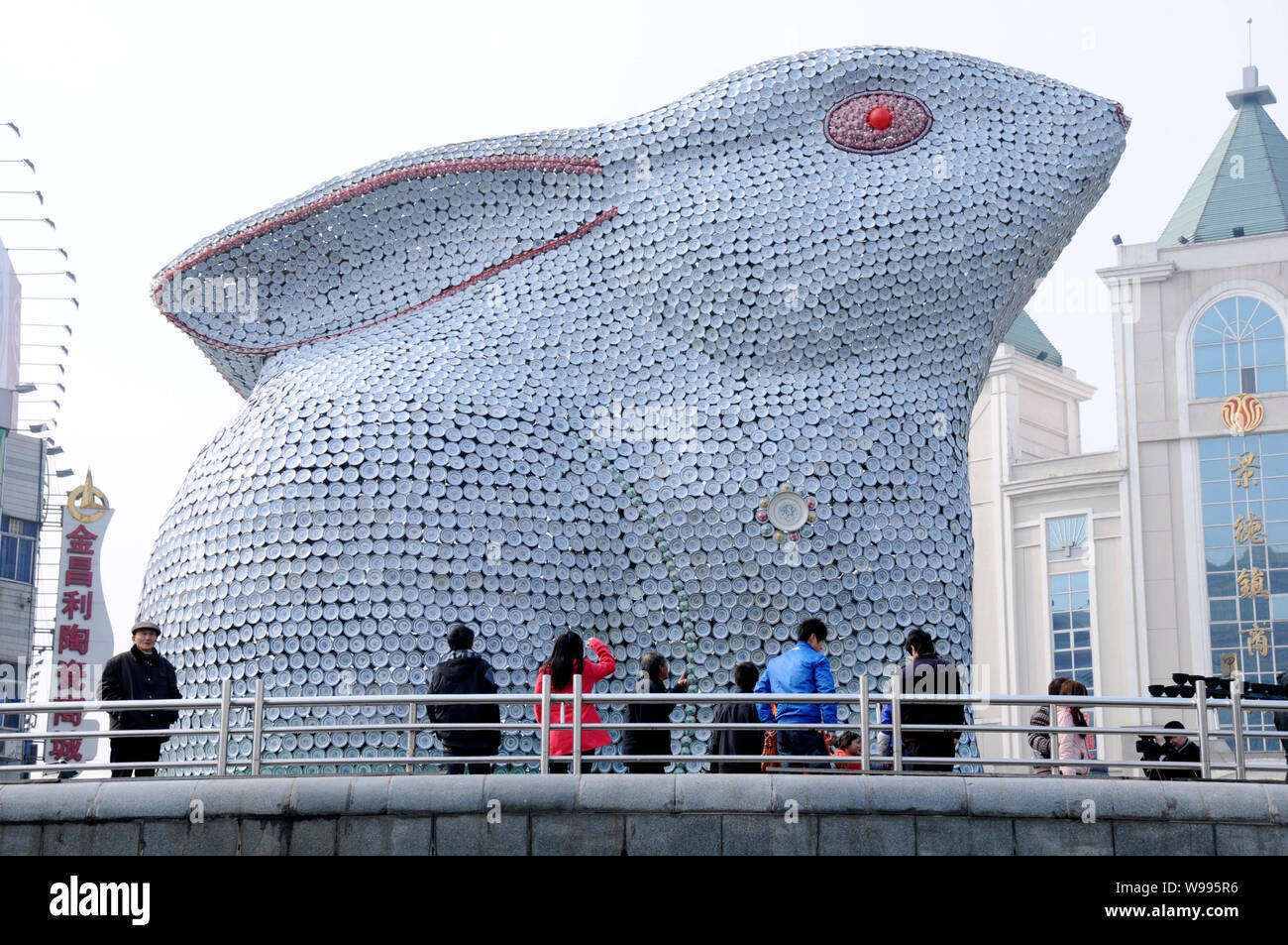 Local Chinese residents look at a huge rabbit consisting of more than ...