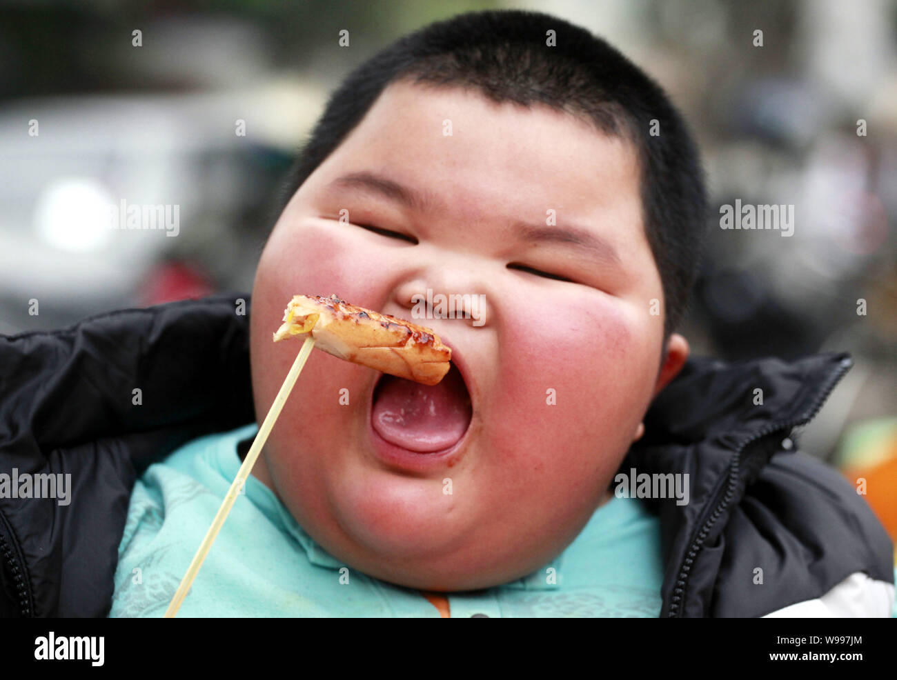 The fattest child, Lu Zhihao, eats BBQ food in Foshan, southeast Chinas Guangdong Province, 29 March 2011.   Lu Zhihao is an obese child hailing from Stock Photo