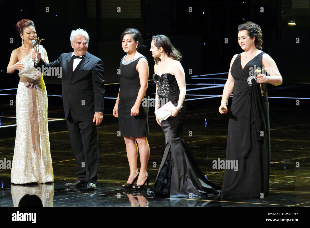 Macedonian actor Sevket Emrulla, second left, holds up the trophy for