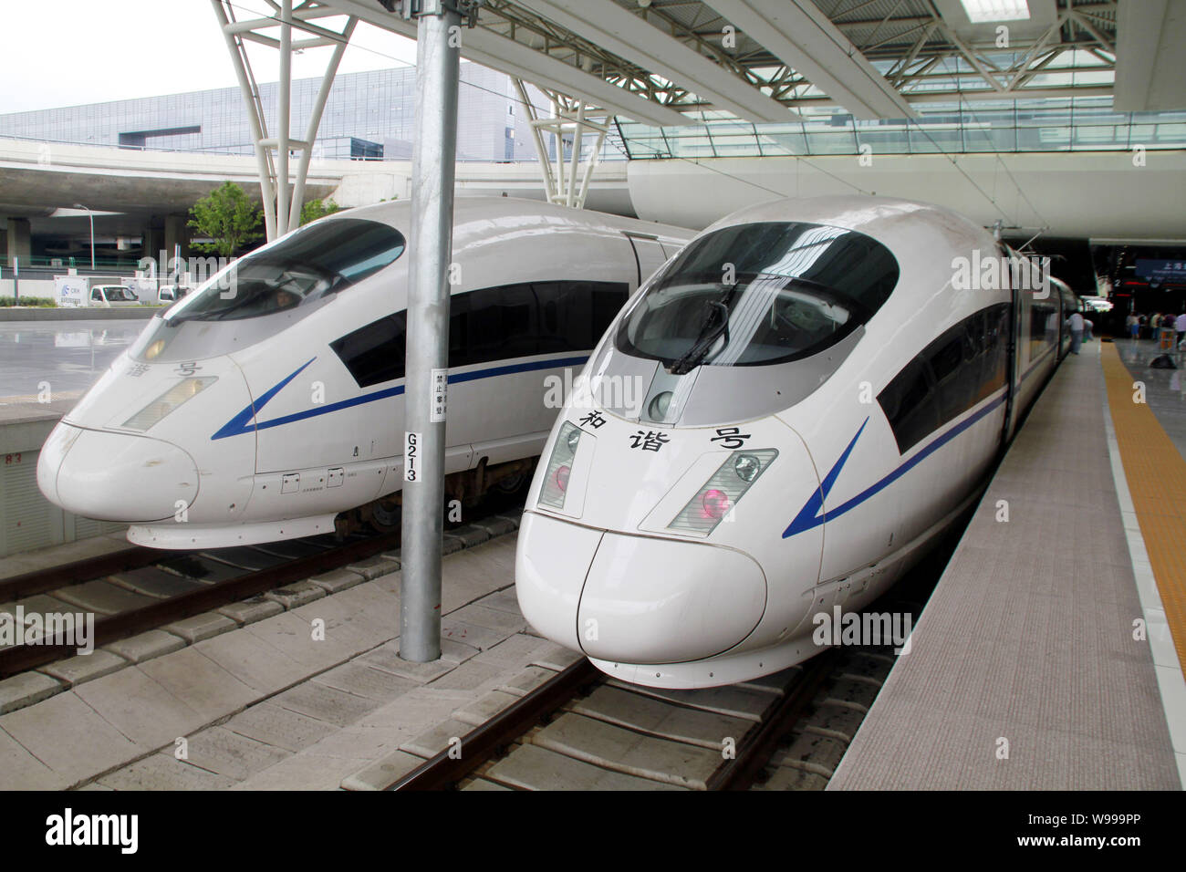 --FILE--Two CRH380B trains, manufactured by China CNR Corporation Limited, are pictured at the Shanghai Hongqiao Railway Station in Shanghai, China, 1 Stock Photo