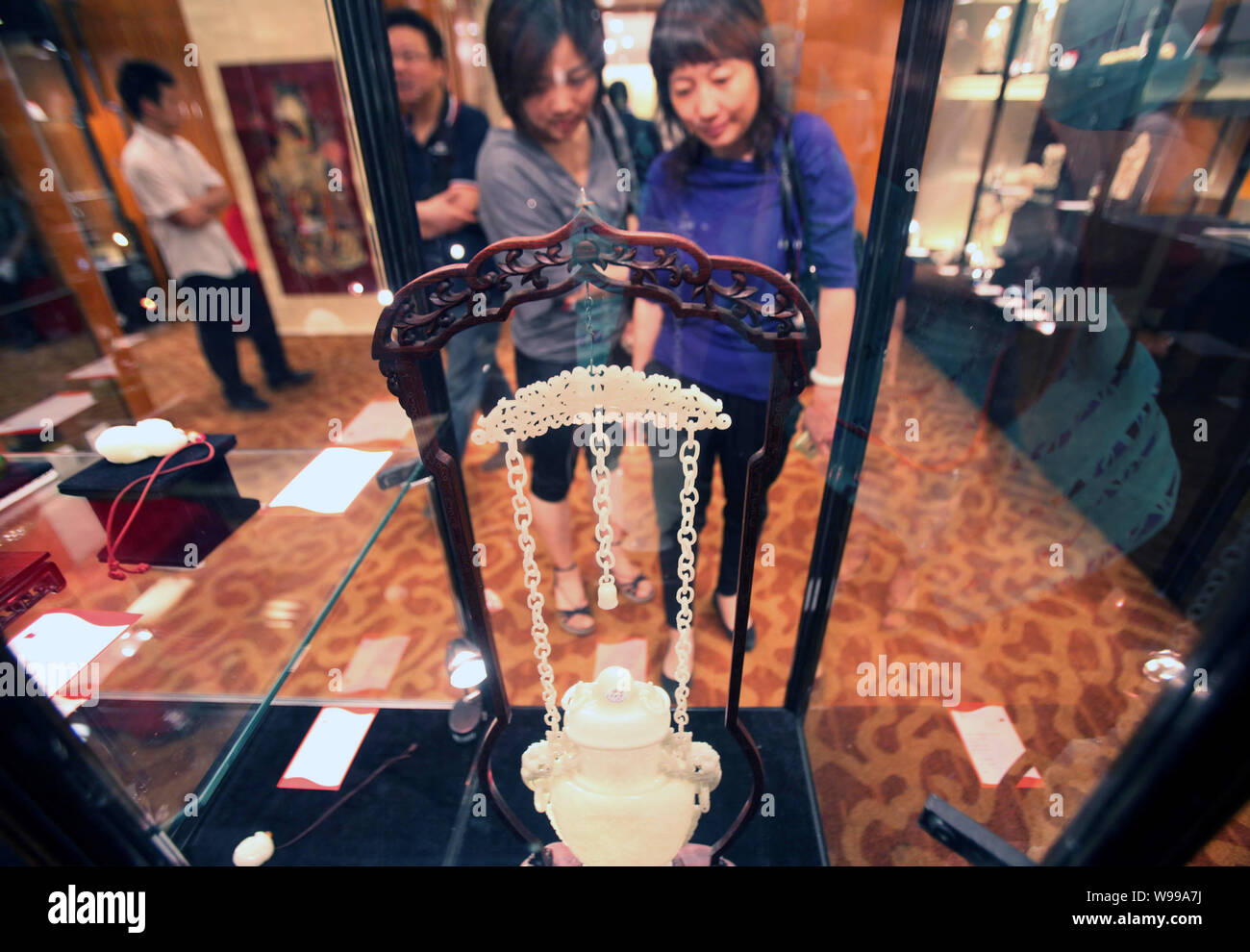 FILE Visitors look at a jade bottle during the preview of an auction FILE Visitors look at a jade bottle during the preview of an auction