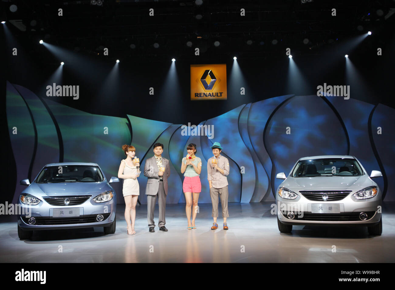 --FILE--Chinese hosts present the Renault Fluence at the 798 Art District in Beijing, China, 9 June 2011.  Whether or not Renault begins manufacturing Stock Photo
