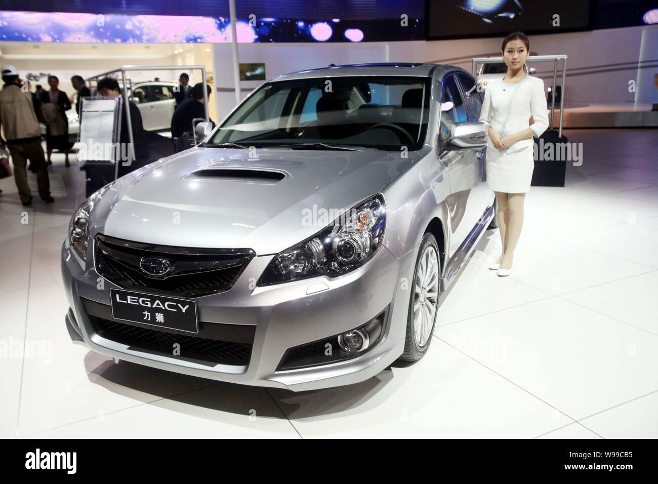 --FILE--A model poses next to the Subaru Legacy during the 8th China (Guangzhou) International Automobile Exhibition, known as Auto Guangzhou 2010, in Stock Photo